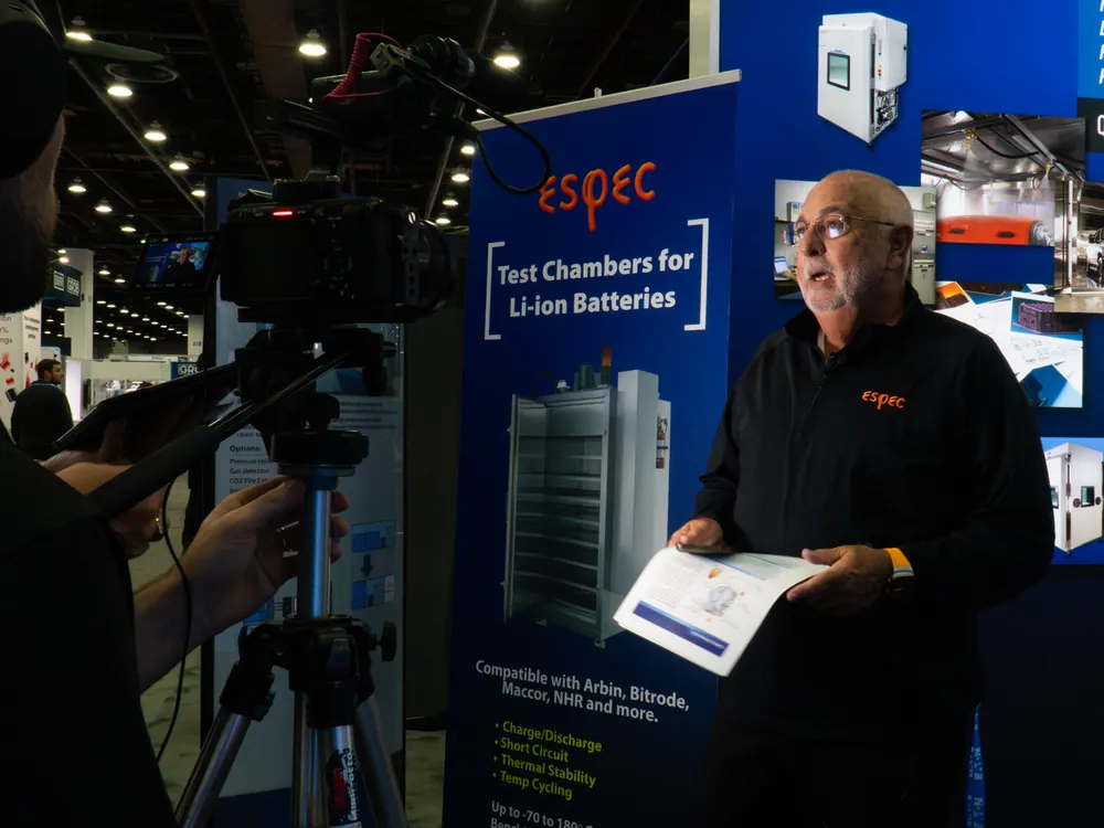 Trade show video production crew filming exhibitor booth coverage at ESPEC